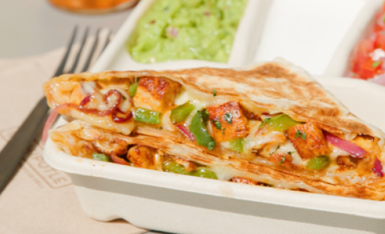 A Chipotle Quesadilla with adobo chicken, melted monterey jack cheese, and fresh fajita veggies with a side of fresh tomato salsa, sour cream, and freshly made guacamole.